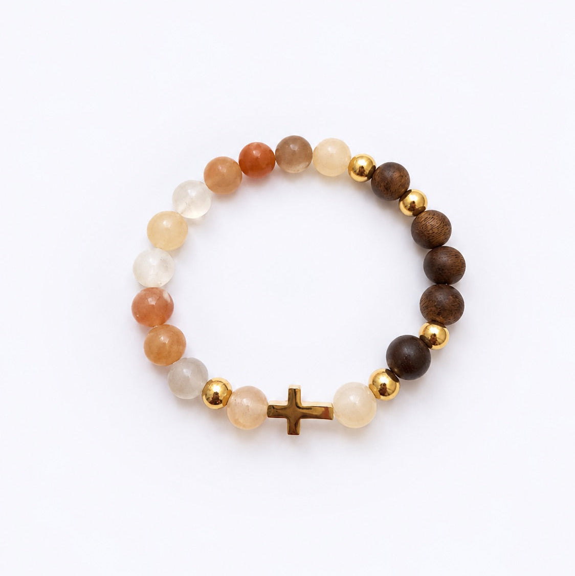 A beaded stretch bracelet featuring a mix of brown wood beads, translucent white and orange stone beads, and polished gold spacer beads, finished with a small gold cross at the front, displayed on a clean white background.